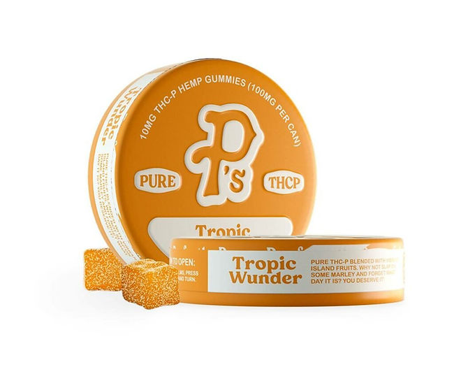 Orange circular container of Pushin P's Pure THCP Gummies, labeled "Tropic Wunder," with 10 pieces. Two smaller orange tins visible alongside, with a few golden gummy cubes displayed in front, showcasing the product's appearance and packaging.