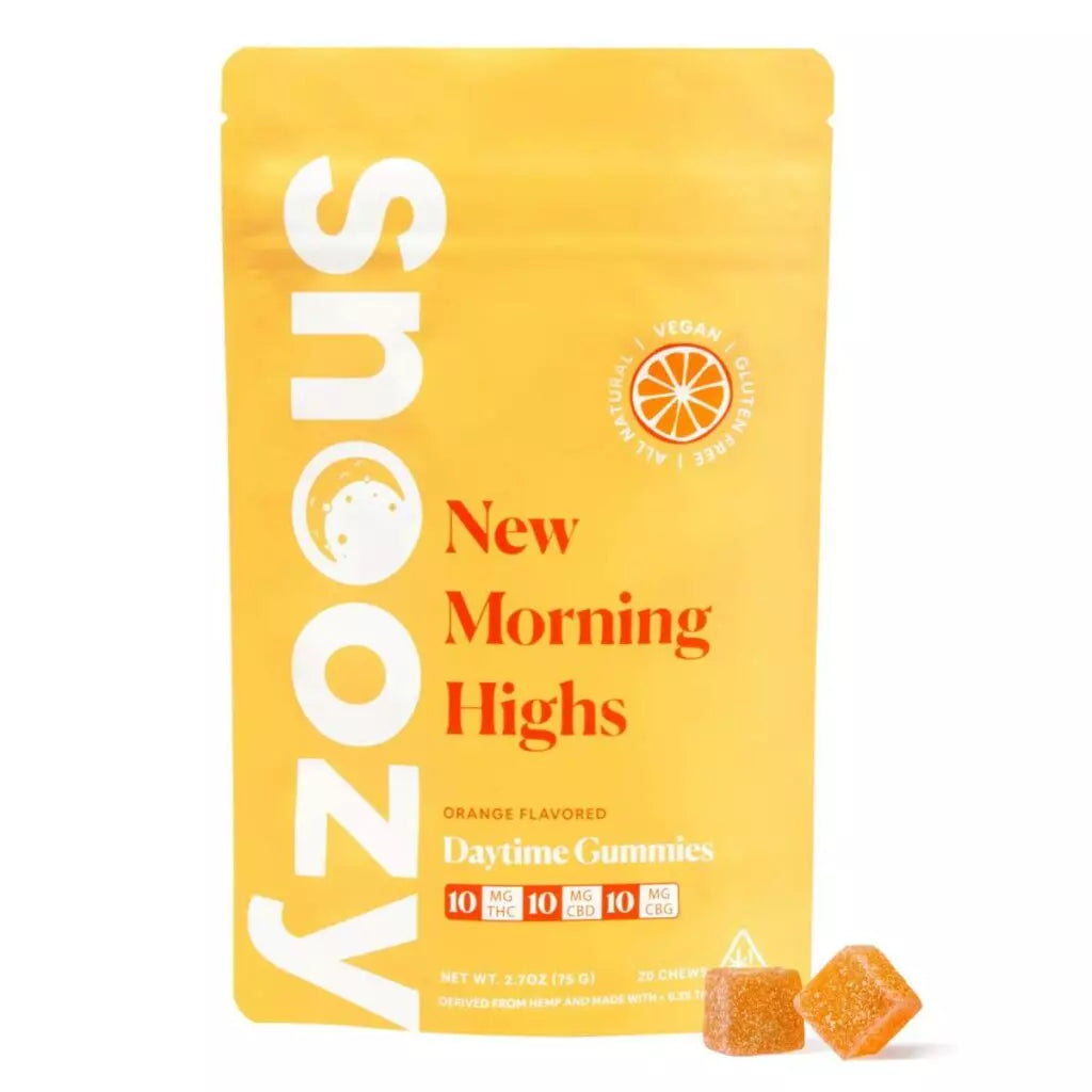 Yellow packaging of Snoozy New Morning Highs orange-flavored daytime gummies, featuring brand logo and product details. Two orange-colored gummy cubes visible at the bottom of the image.