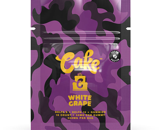 Cake Delta 8 and Delta 10 White Grape Gummies packaging, featuring purple camouflage design, yellow logo, and product details. Contains 10 gummies, 50mg per piece, 500mg total per bag.